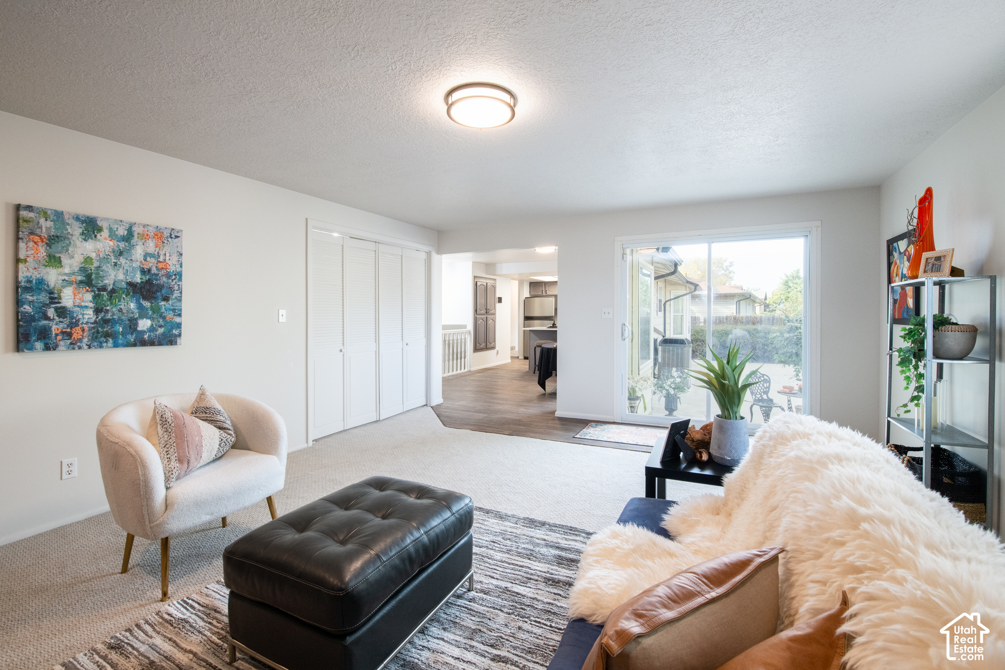 Furnished living room with a sliding glass door opening onto a patio.