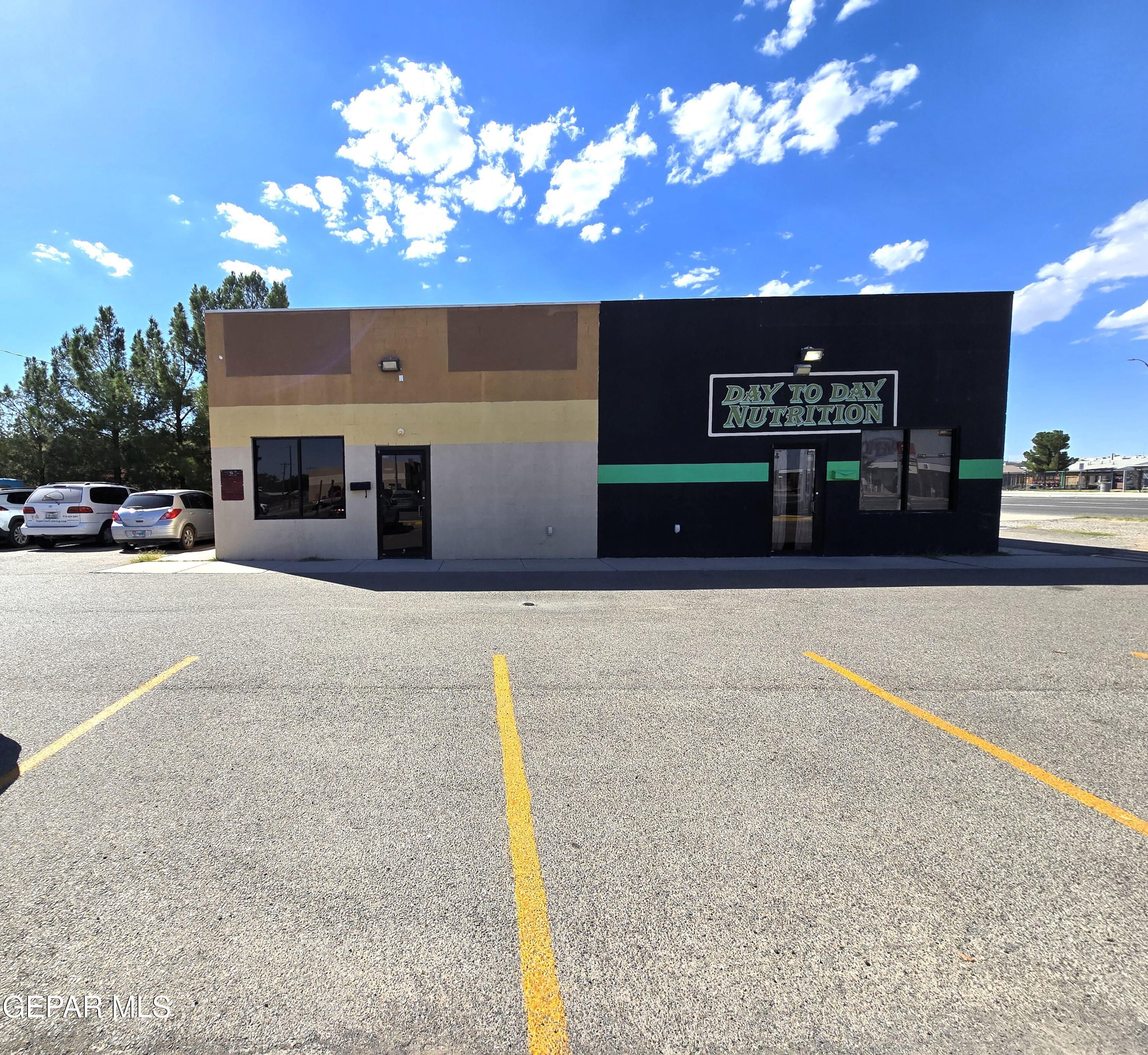 Commercial storefront with a black-and-tan facade, green stripe, and Day to Day Nutrition sign.
