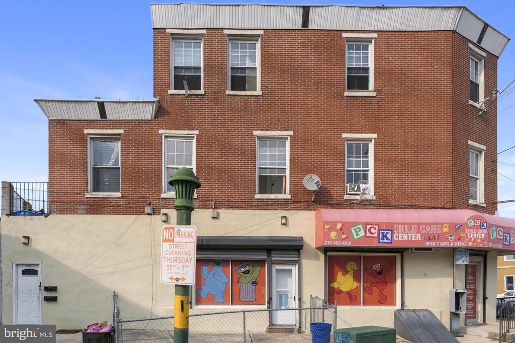 Red-brick building with a child care center storefront and pink awning.