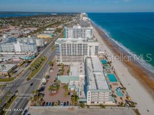 Aerial view of beachfront condominiums beside the Atlantic Ocean and coastal road.
