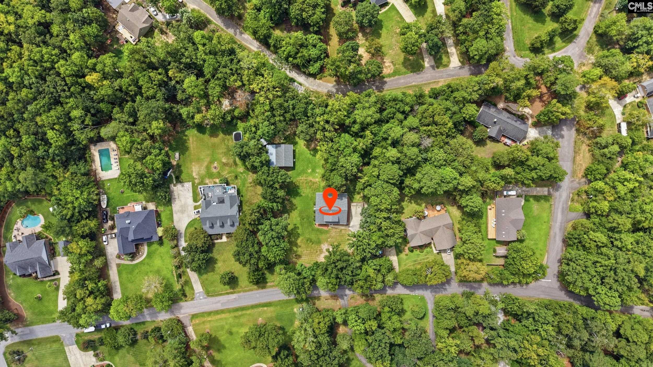 Aerial view of 119 Derrick Drive, marked among wooded residential lots.