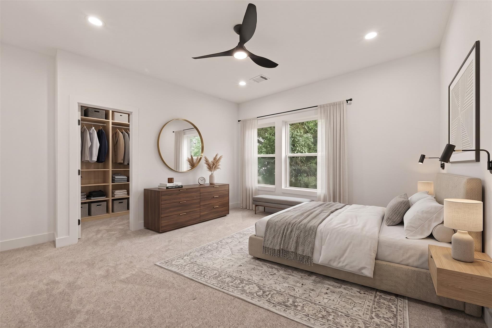 Bedroom with an open closet, wood dresser, round mirror, and two curtained windows.