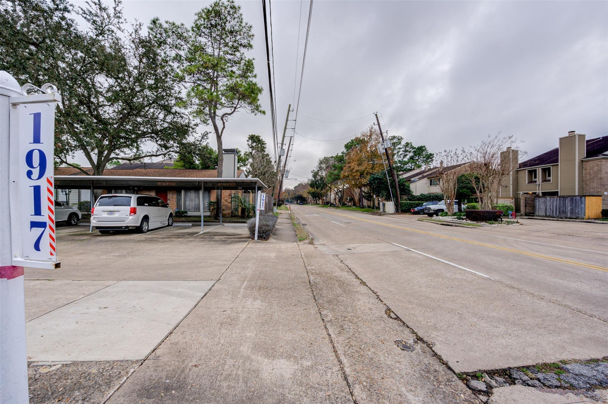 Street-facing view of 1917 Augusta Drive, with covered parking and neighboring residences.
