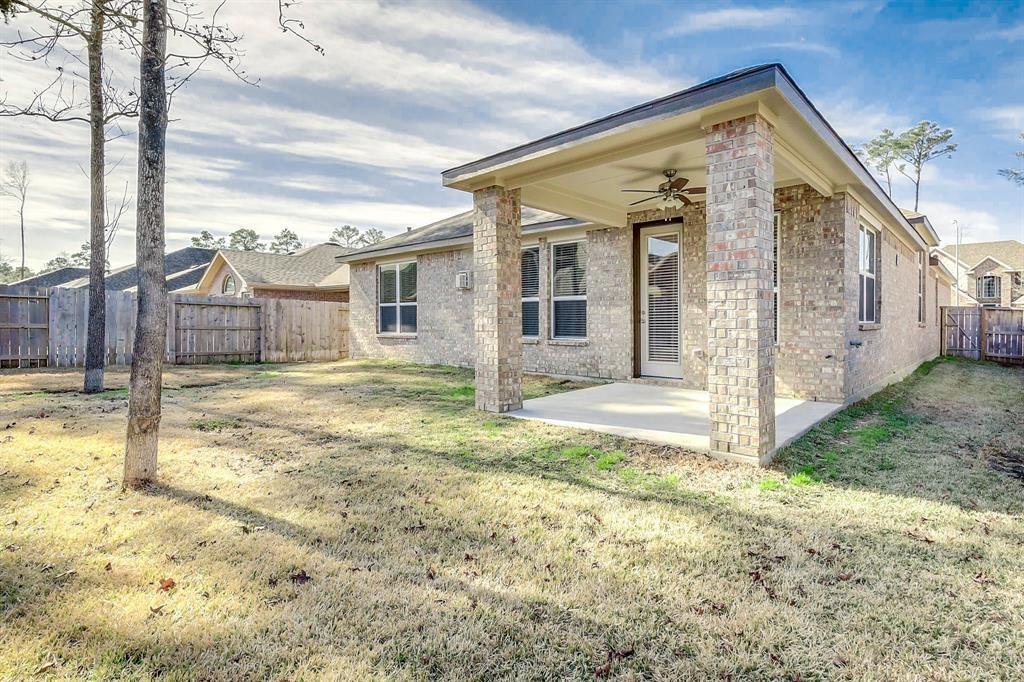 Single-story brick home with a covered patio and fenced backyard.