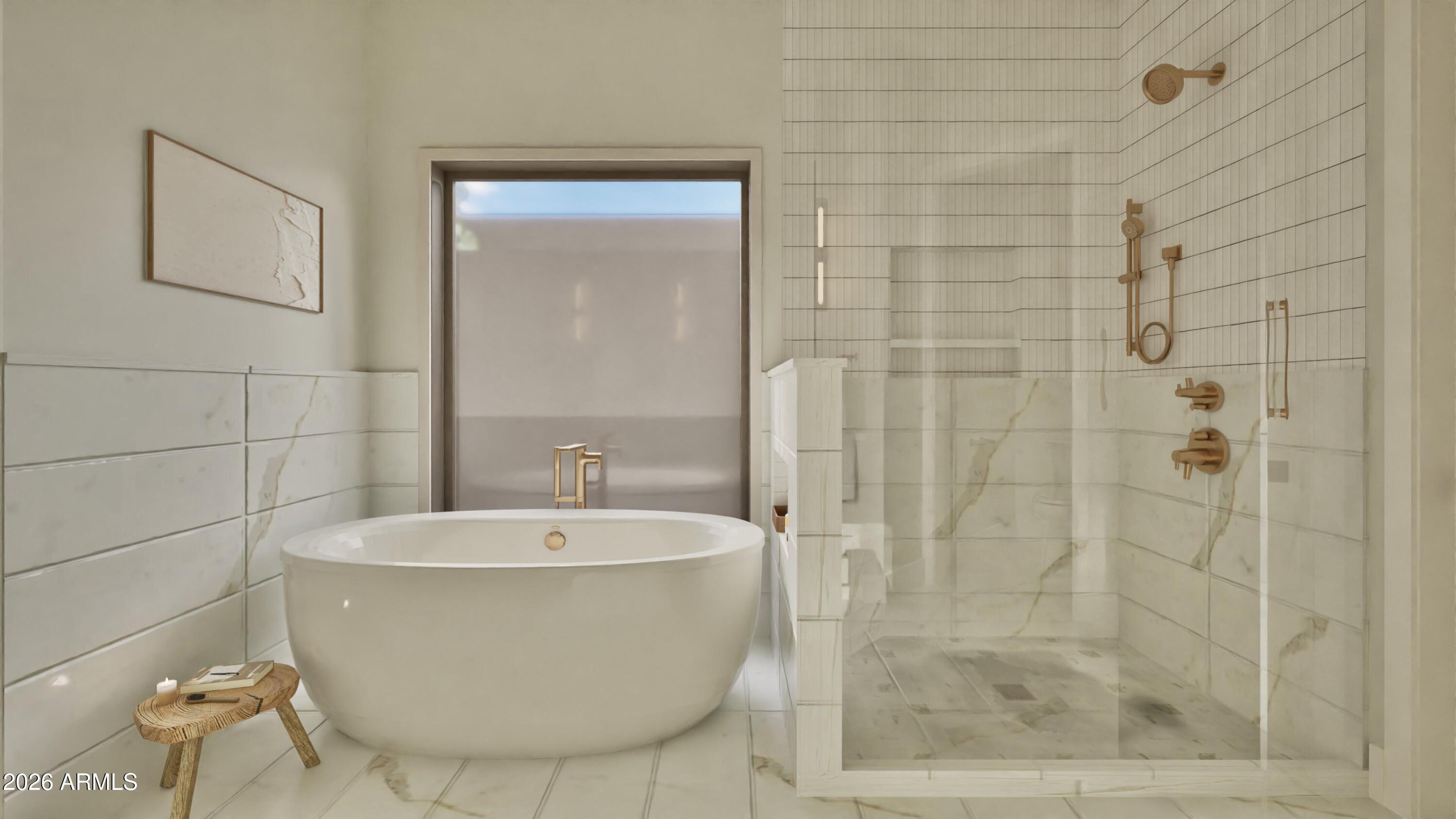 Modern bathroom with a freestanding soaking tub, glass walk-in shower, and brass fixtures.
