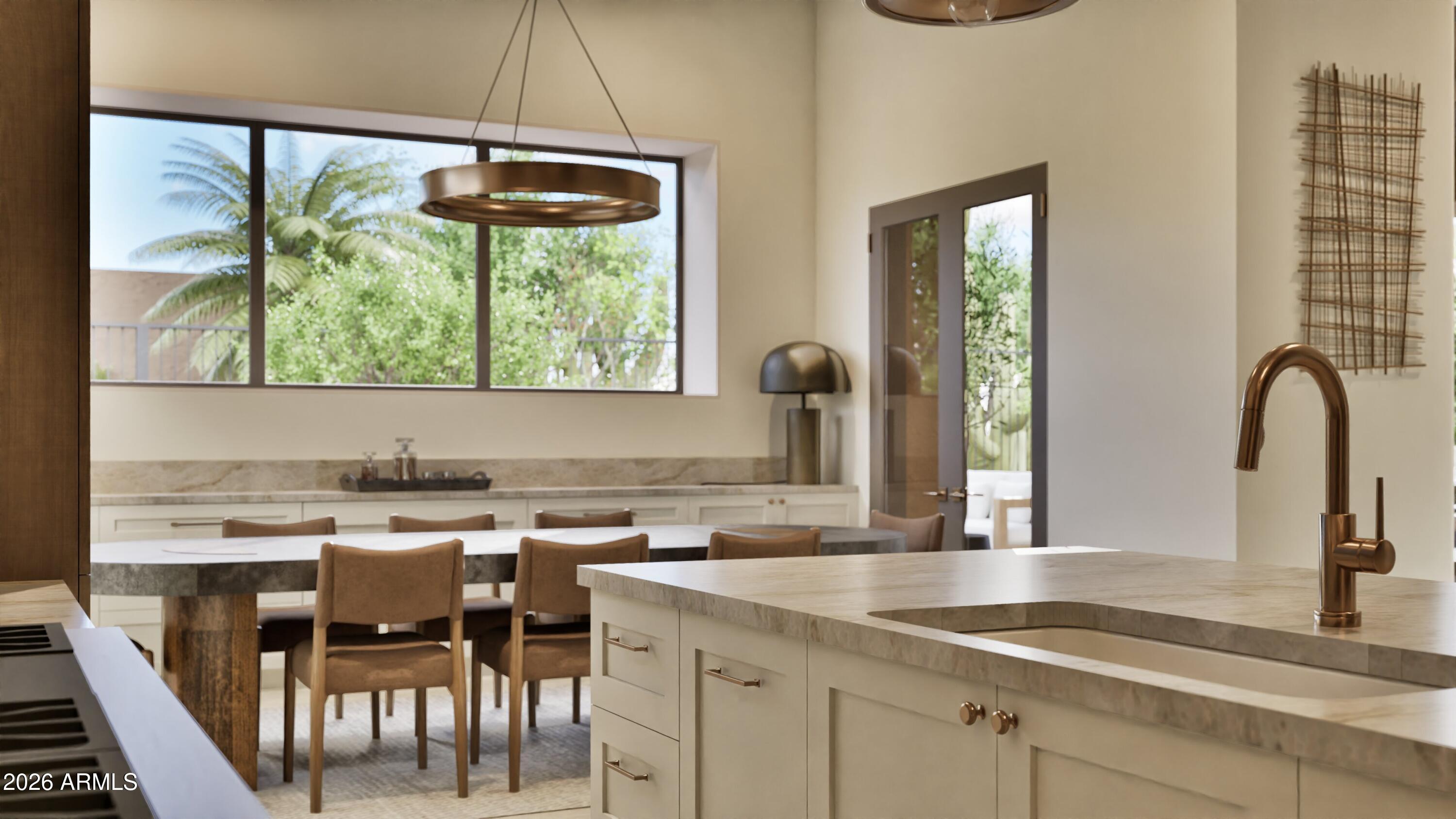Kitchen and dining area with a stone island, bronze faucet, and wide windows overlooking greenery.