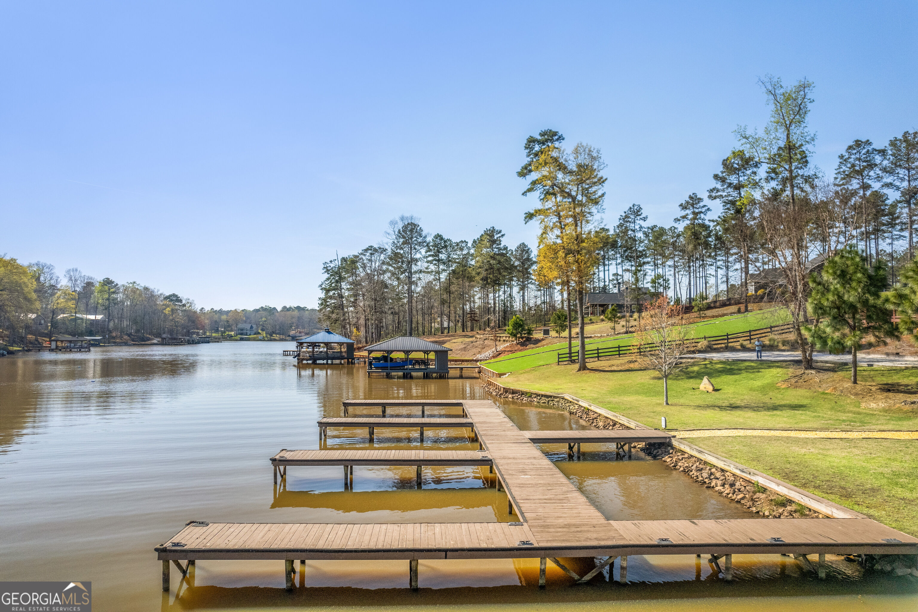 Lakefront docks extend from a landscaped, tree-lined shore.