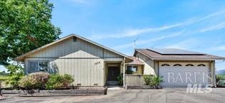 Single-story building with a wide garage door and landscaping along the front.