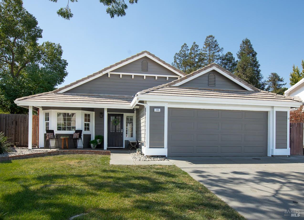 Gray single-story home with white trim, a covered porch, and a two-car garage.