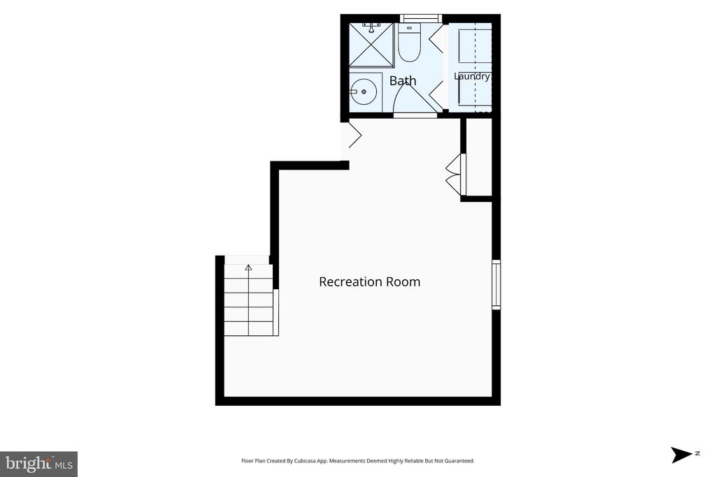 Basement floor plan showing a recreation room, bathroom, laundry area, and stairs.