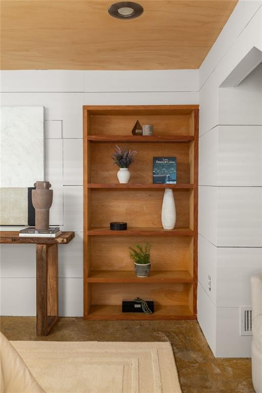 Built-in wood shelving with decor beside a console table in a modern interior.