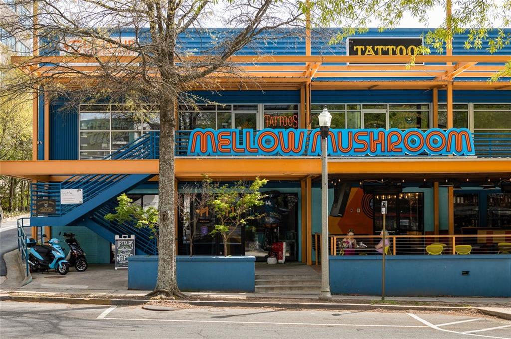 Mellow Mushroom storefront with a blue-and-orange facade and large sign.