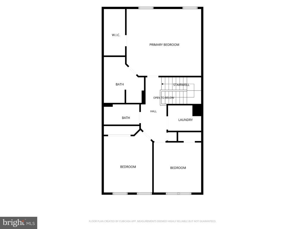 Second-floor plan showing a primary bedroom, two bedrooms, bathrooms, laundry, hall, and stairwell.