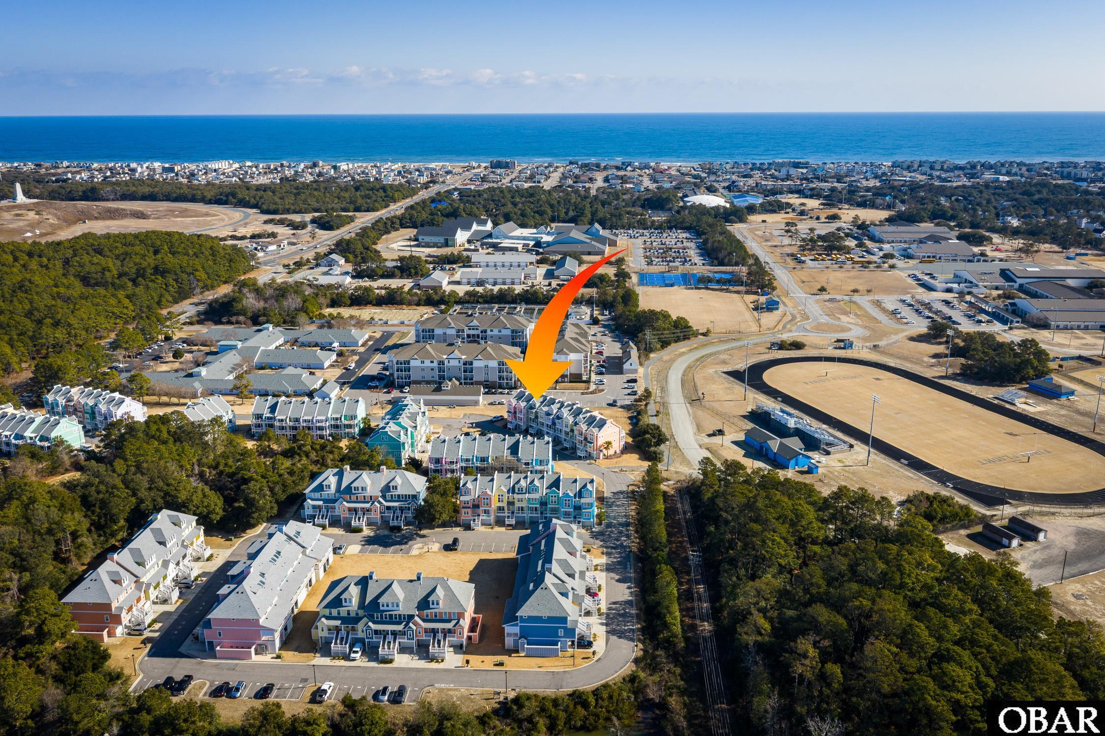 Aerial view of the townhouse community, with an arrow marking the unit near the ocean.