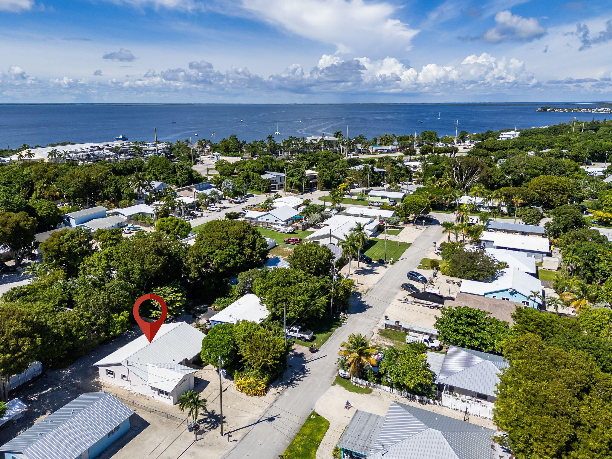 Aerial view of a Key Largo neighborhood, with the marked home near the waterfront.