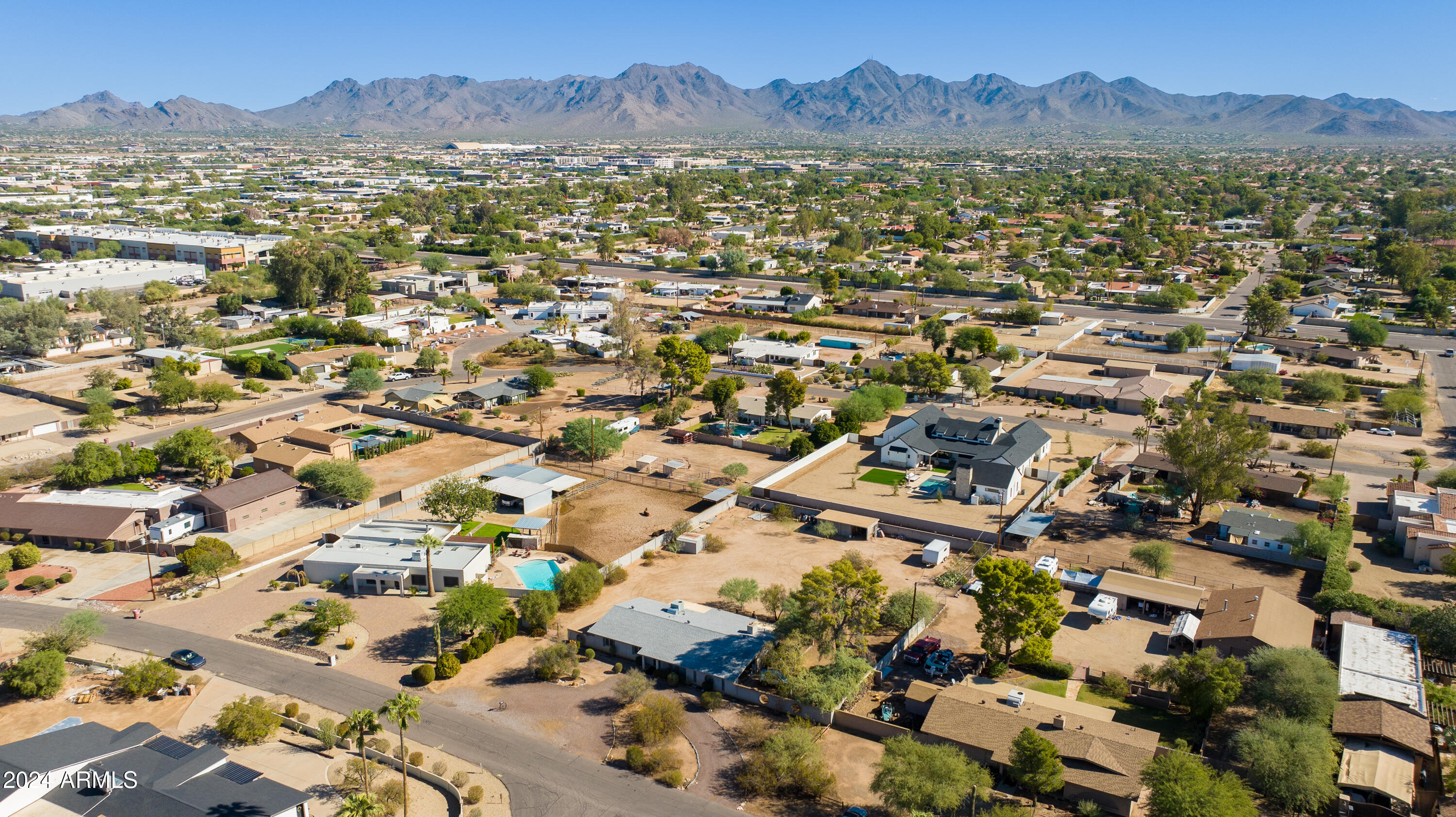 Aerial view of a Scottsdale home and neighborhood, with the McDowell Mountains on the horizon.