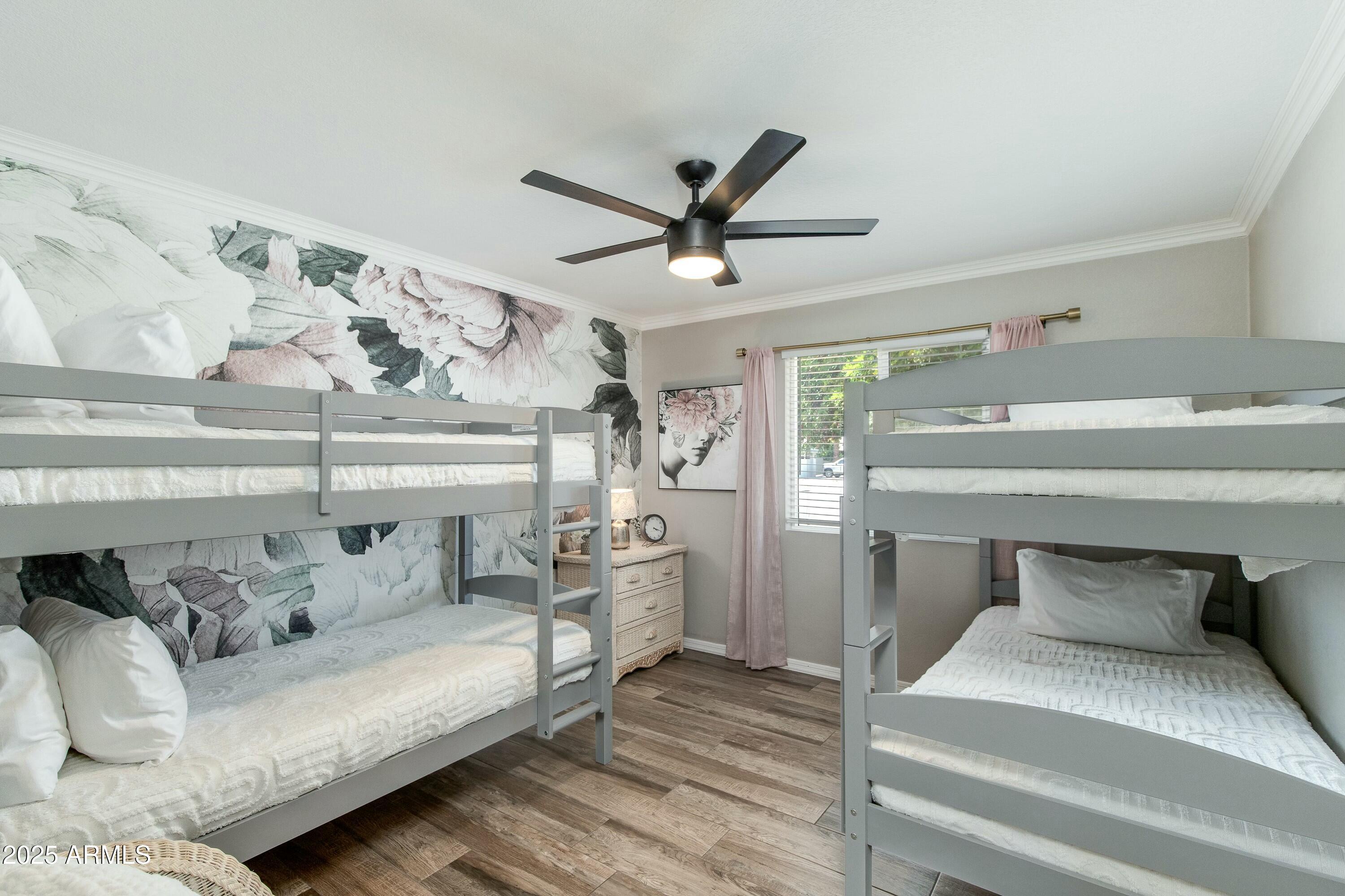 Bedroom with gray bunk beds, floral wallpaper, and pink curtains.