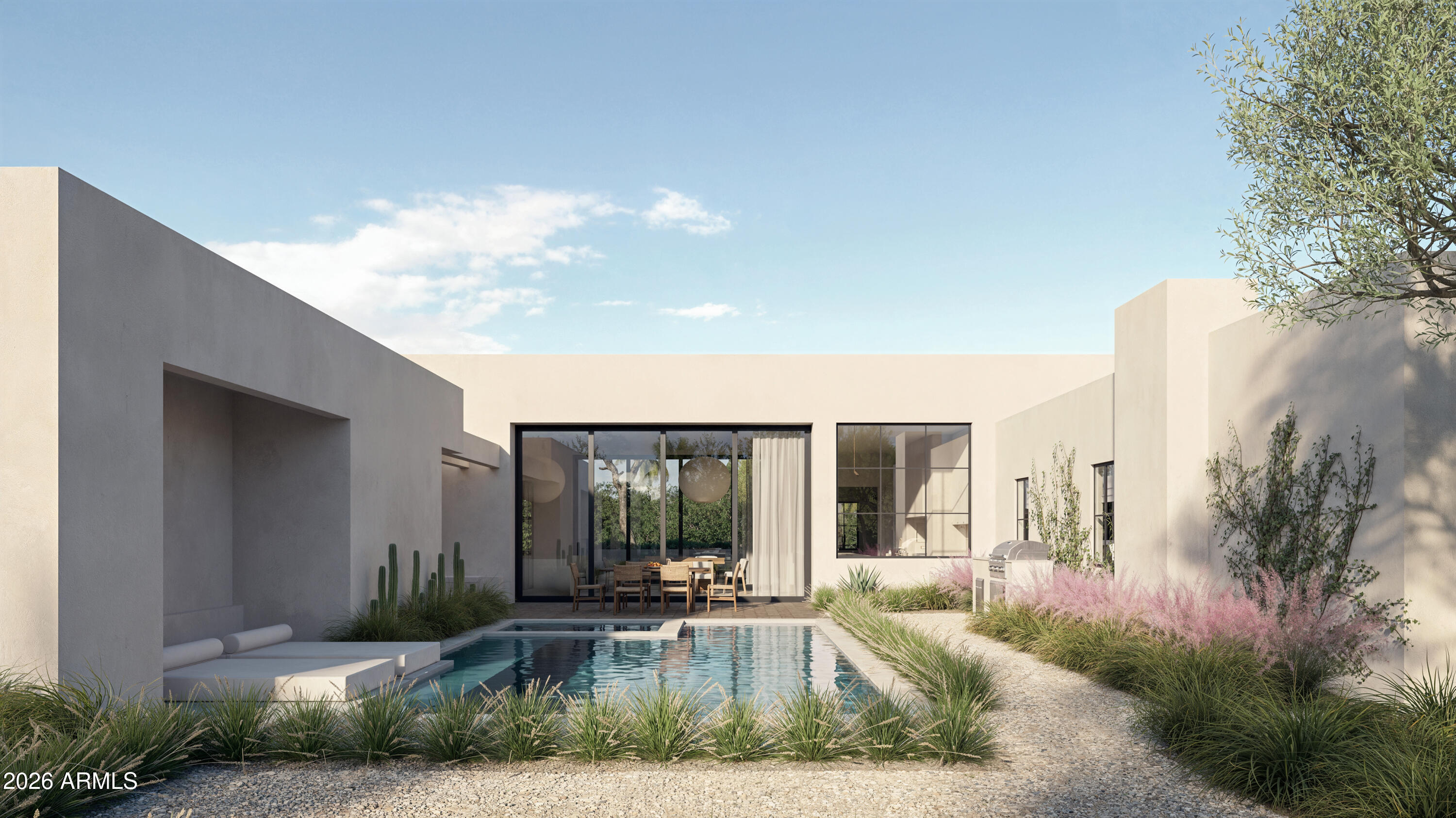 Modern white stucco home with a courtyard pool, glass doors, and desert landscaping.