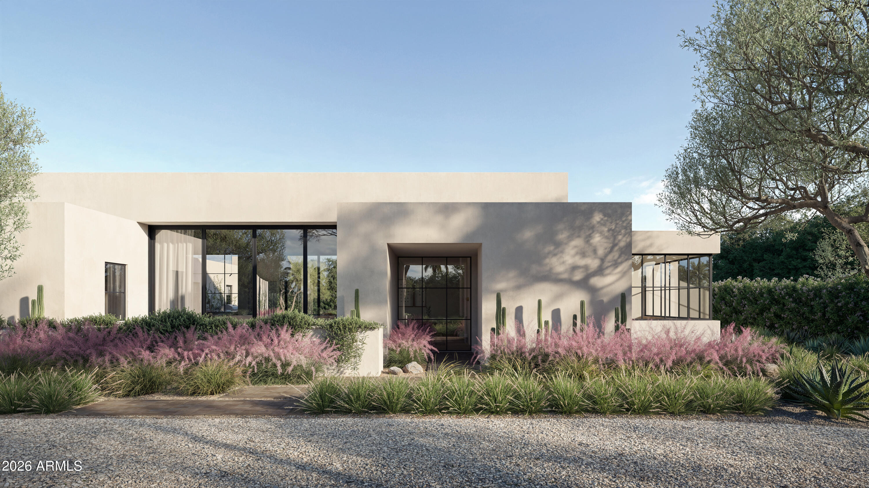 Modern flat-roof home with a recessed entry, expansive black-framed windows, and desert landscaping.