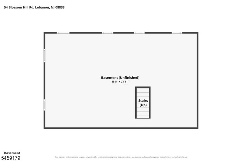Unfinished rectangular basement floor plan with central stairs and windows along two walls.