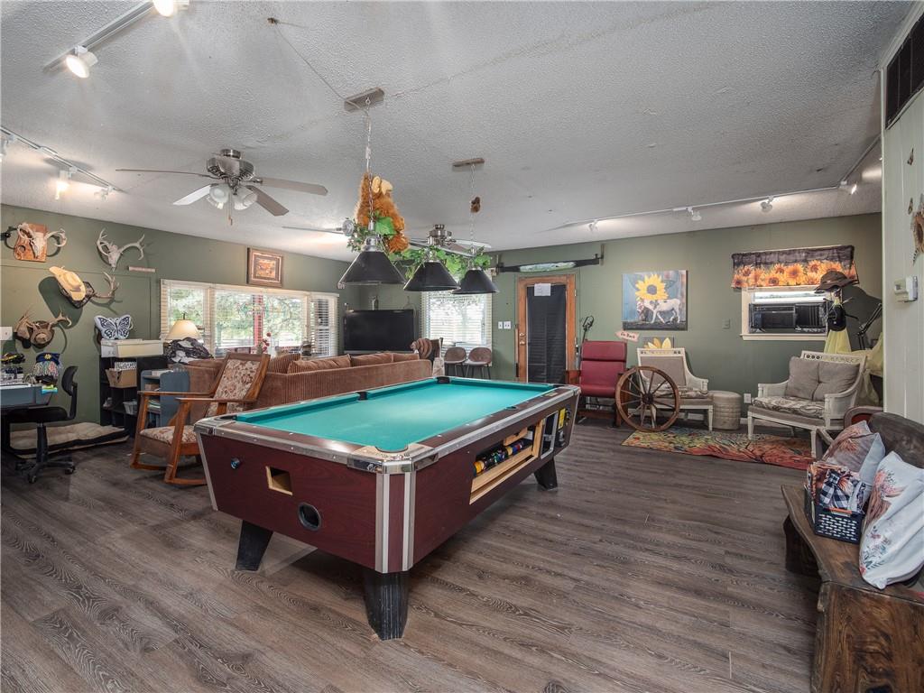 Furnished game room with a full-size billiards table and a sitting area.
