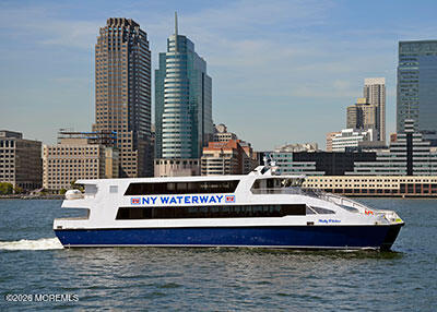 NY Waterway ferry crossing in front of a waterfront city skyline.
