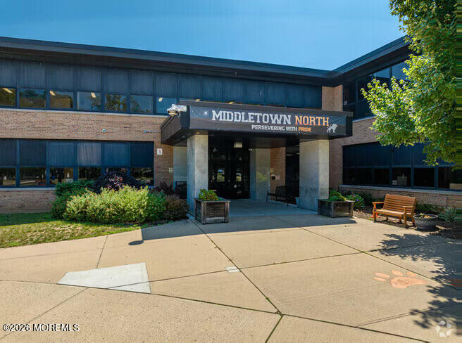Middletown North school exterior with brick facade, central entrance, and landscaped walkway.