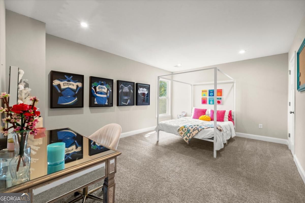Bedroom with a white canopy bed and framed hockey jerseys on the wall.