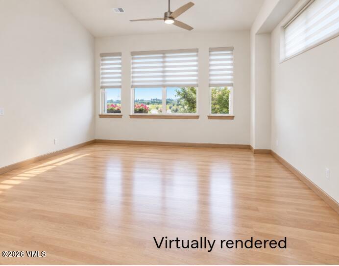 Vacant room with light wood flooring, striped window shades, and a ceiling fan.