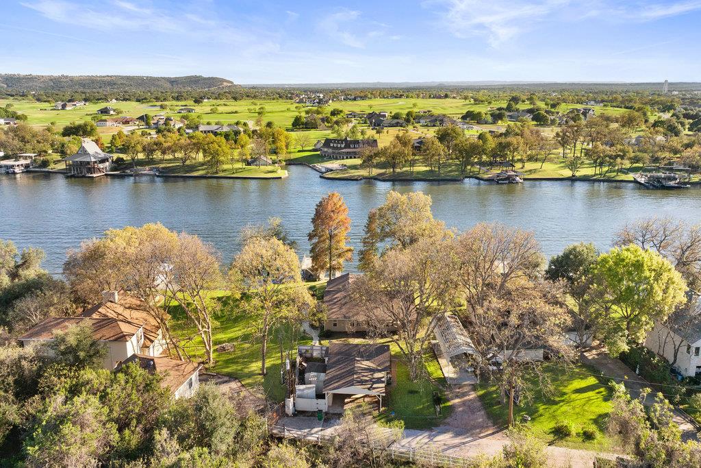 Aerial view of waterfront homes and docks across a broad body of water.