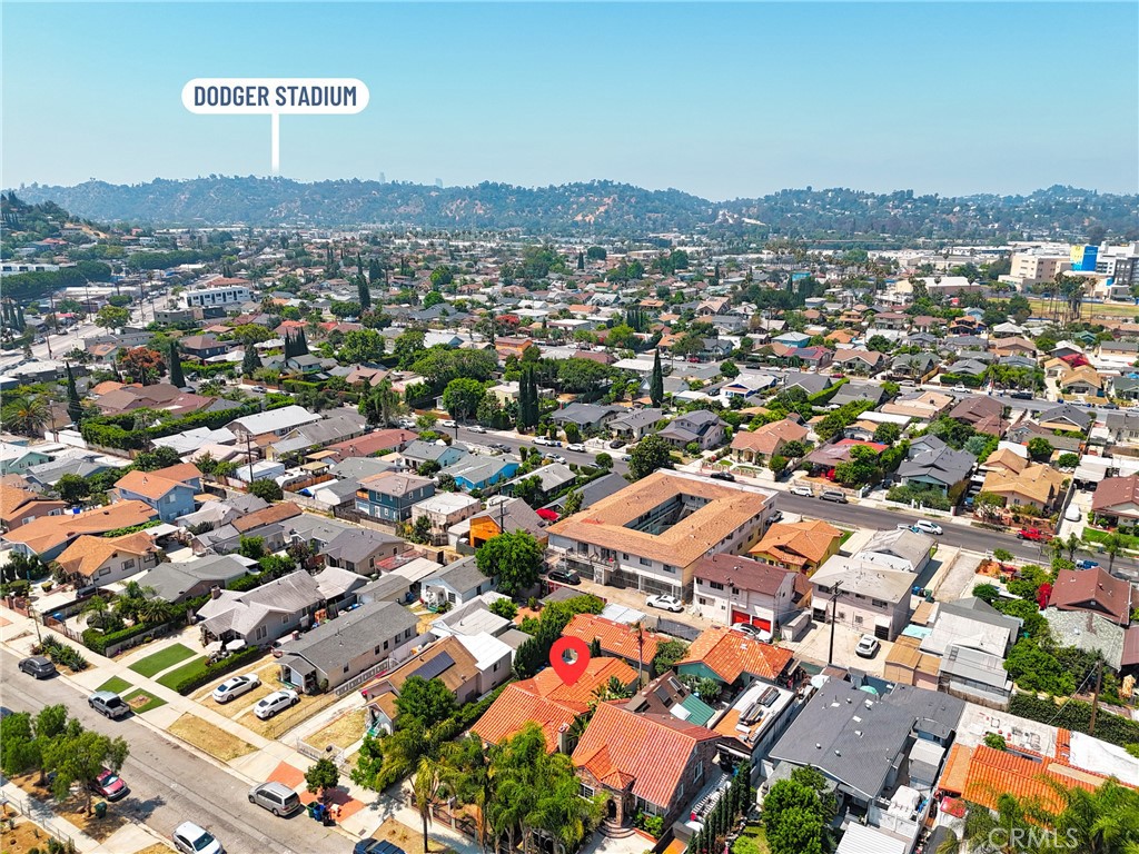 Los Angeles neighborhood aerial with the listed home marked and Dodger Stadium labeled in distance.