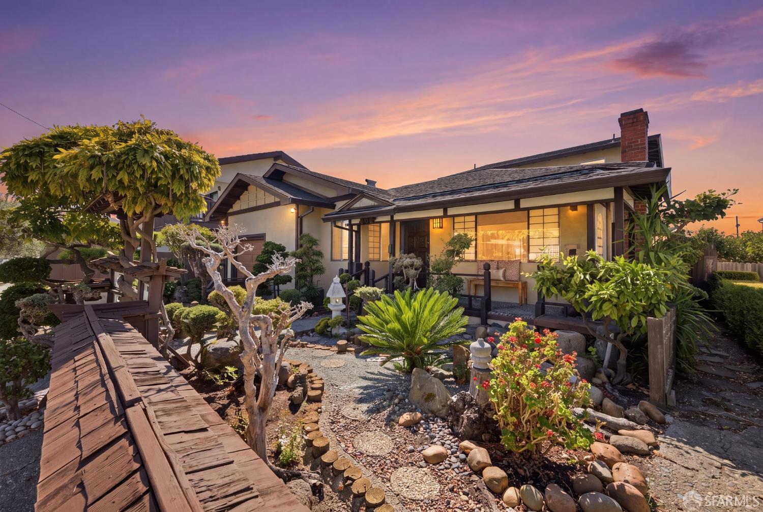 Home at 509 Clayton Avenue with a Japanese-style rock garden and wooden walkway at sunset.