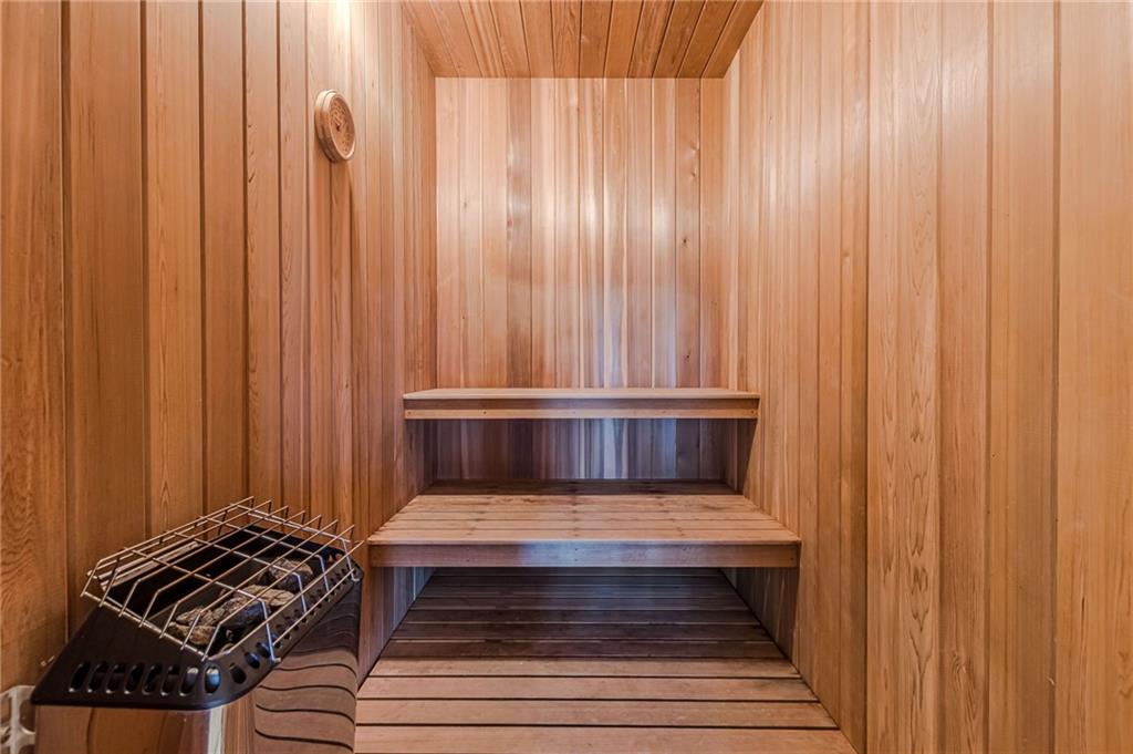Cedar-paneled sauna with tiered benches and an electric heater.