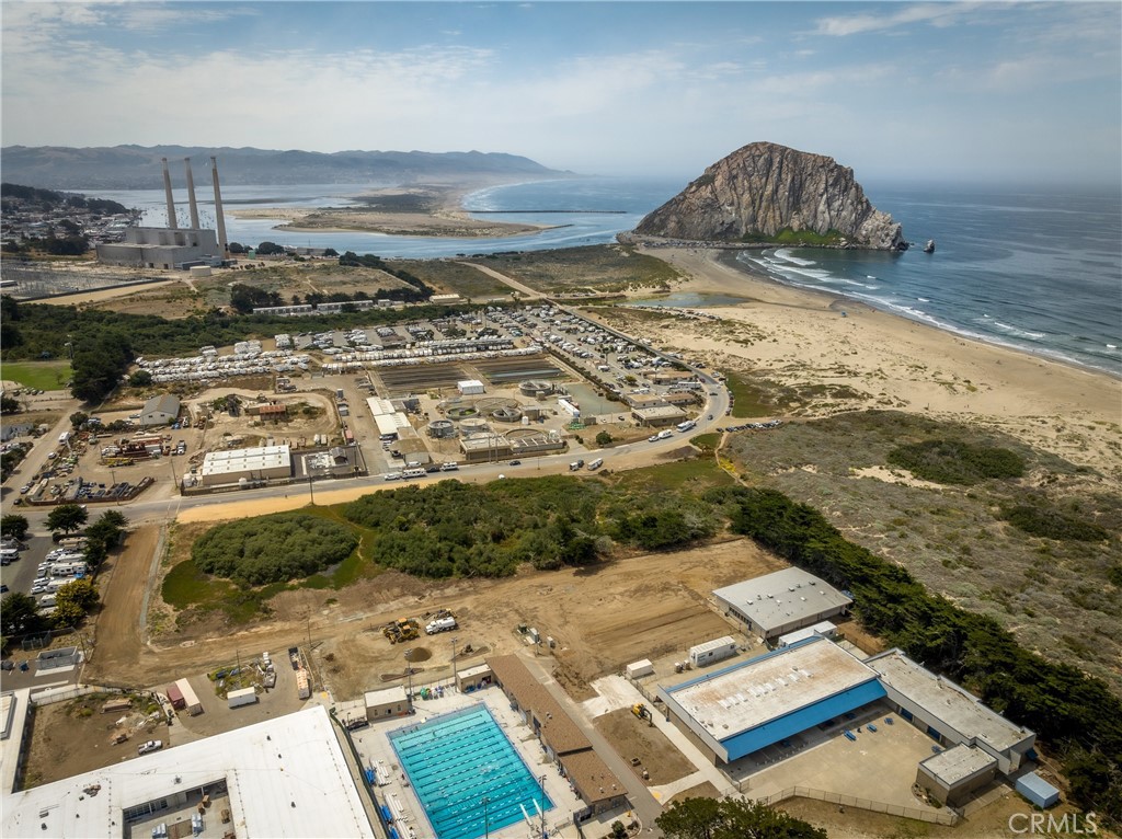 Aerial view of vacant land near Morro Bay, with Morro Rock and the Pacific coastline.