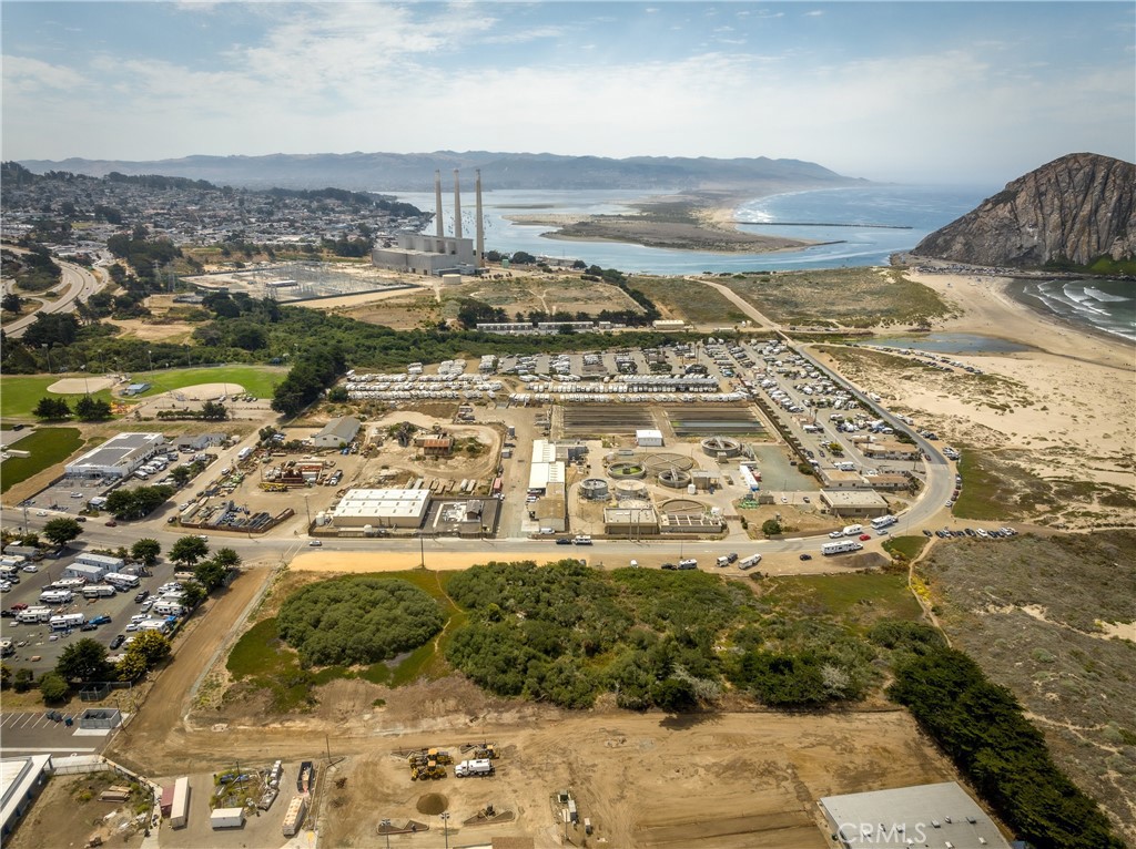 Aerial view of coastal land and a wastewater treatment facility beside Morro Bay.