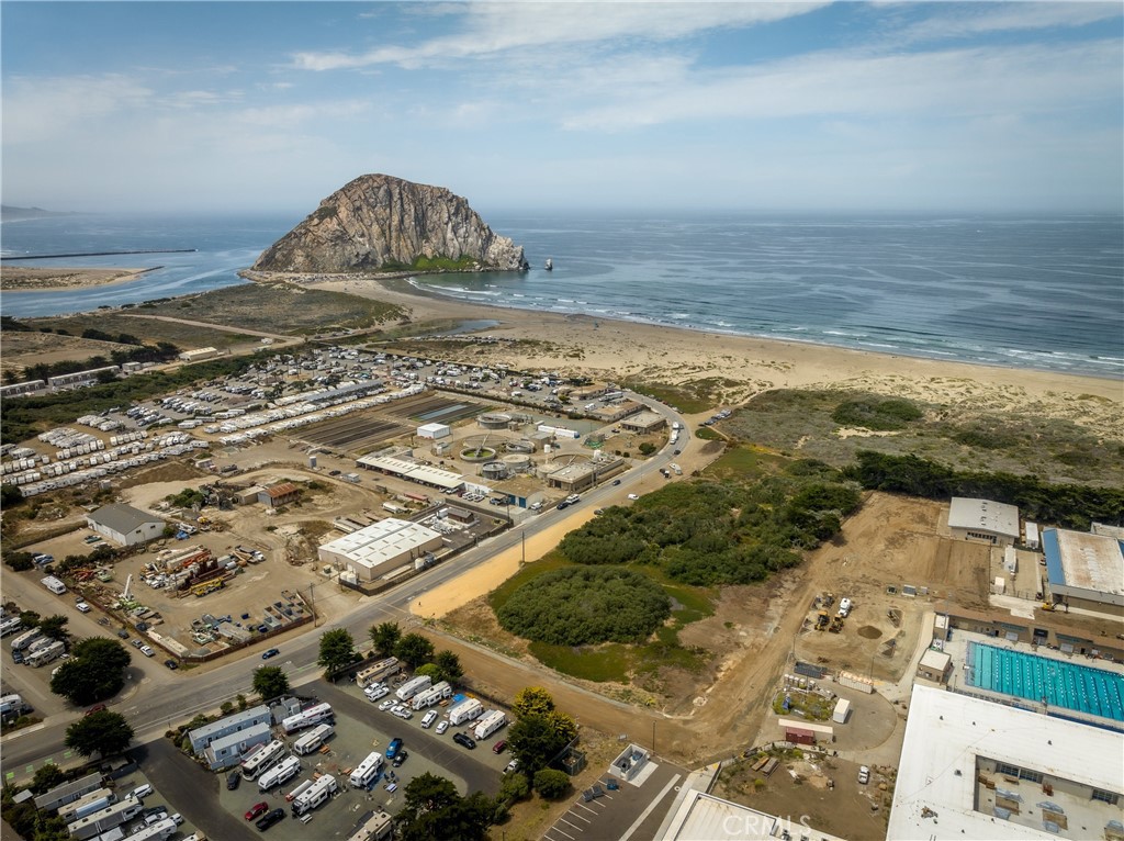 Aerial view of coastal land near Morro Rock, with the Pacific Ocean and nearby development.