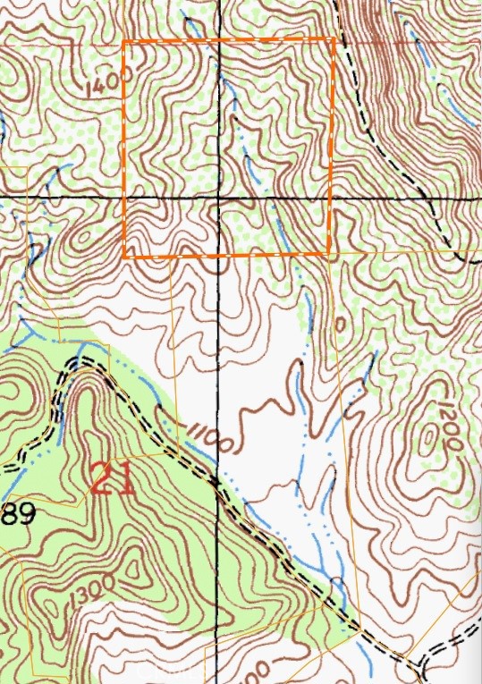 Topographic map showing an orange-outlined parcel among contour lines and waterways.