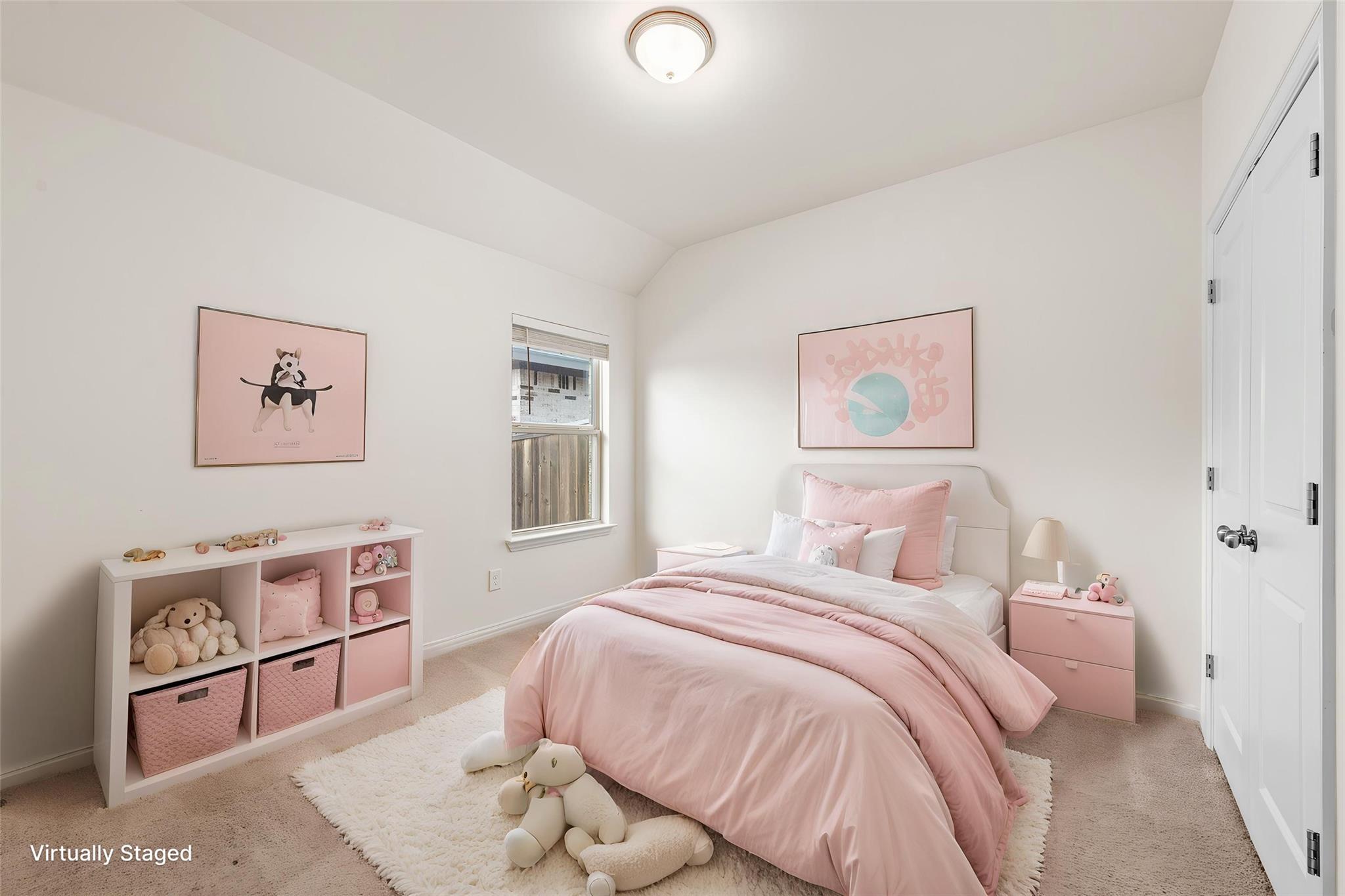 Virtually staged bedroom with pink bedding, toy-filled shelves, and soft pink artwork.