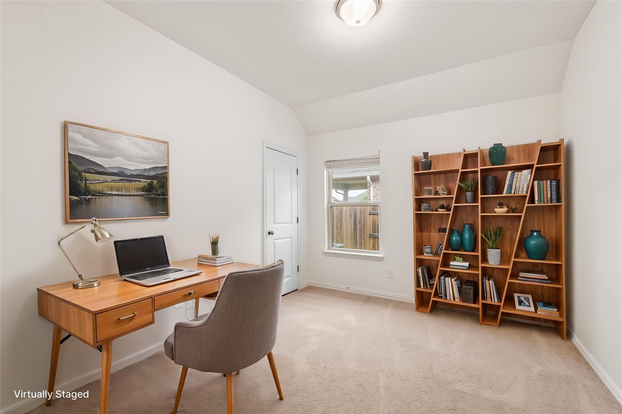 Virtually staged home office with a wooden desk, upholstered chair, and large bookcase.