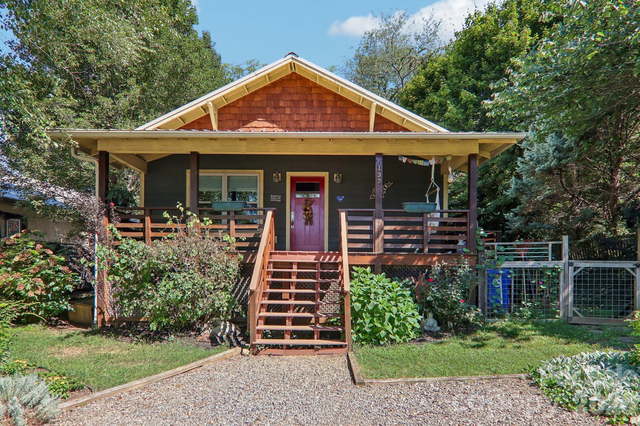 House at 137 Sulphur Springs Road with a covered porch, wooden steps, and red front door.