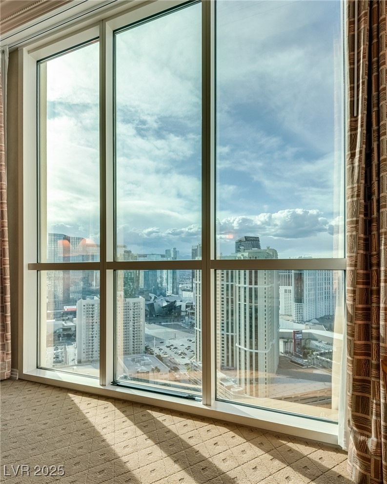 Unfurnished high-rise room with floor-to-ceiling windows overlooking the Las Vegas skyline.