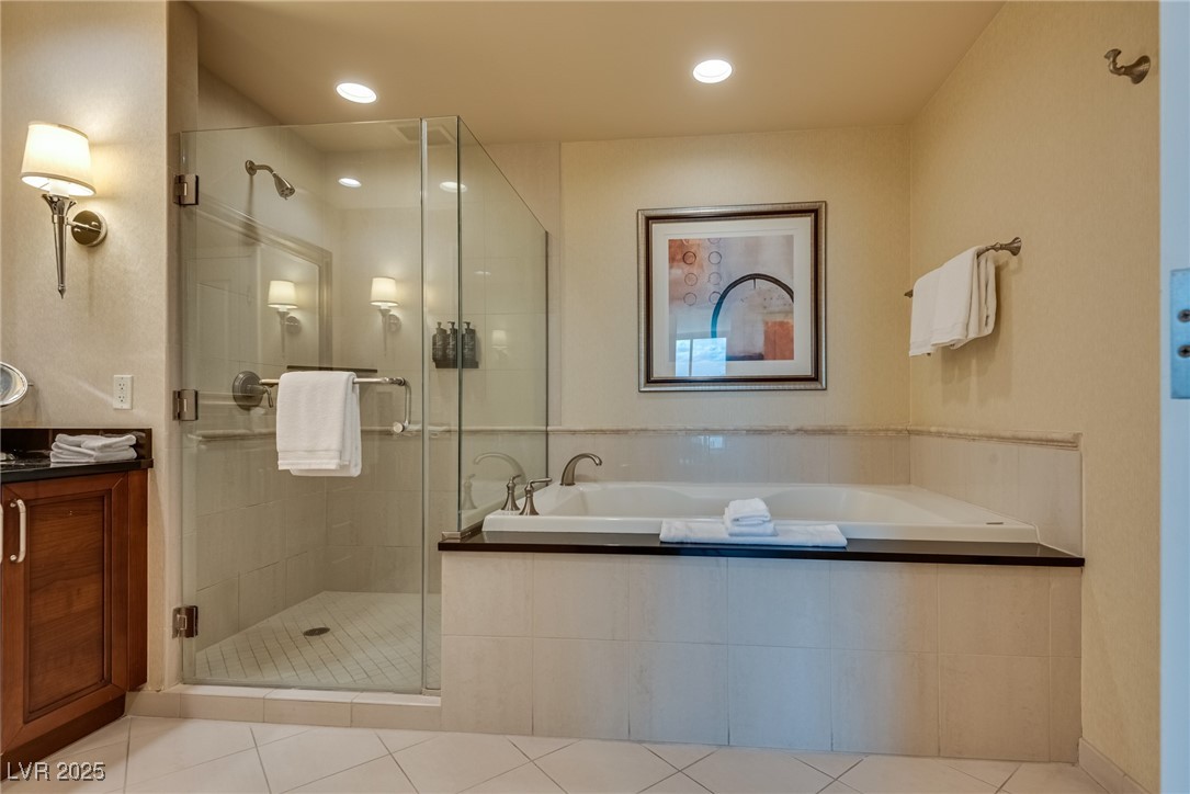 Bathroom with a glass-enclosed shower and built-in soaking tub.