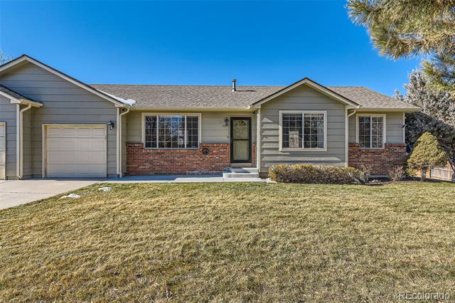 Single-story gray and brick home with an attached garage and broad front lawn.