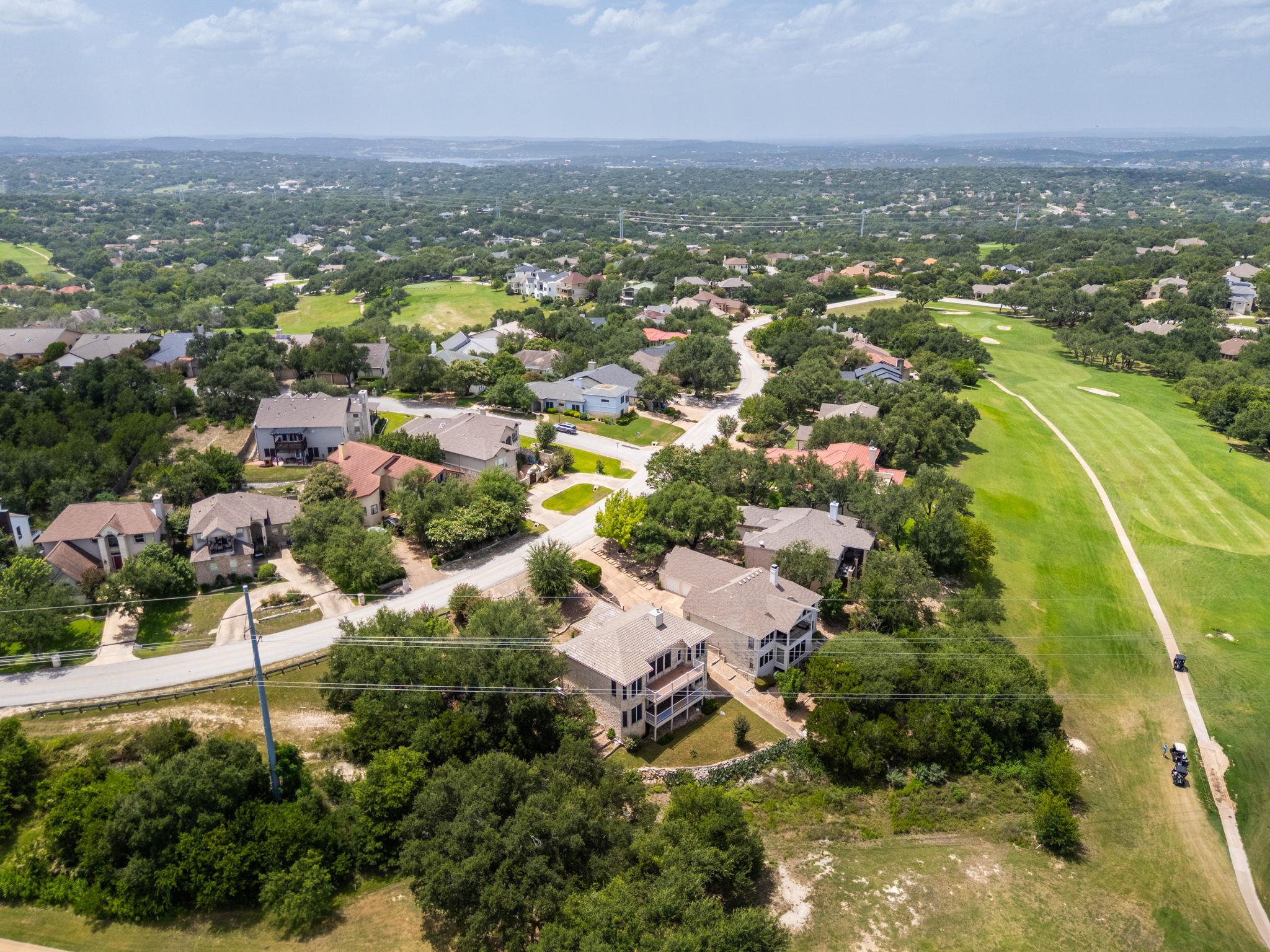 Aerial view of homes bordering a golf course fairway.
