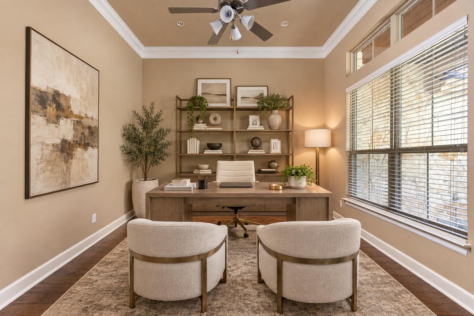 Furnished home office with a wood desk, built-in shelving, and wide windows.