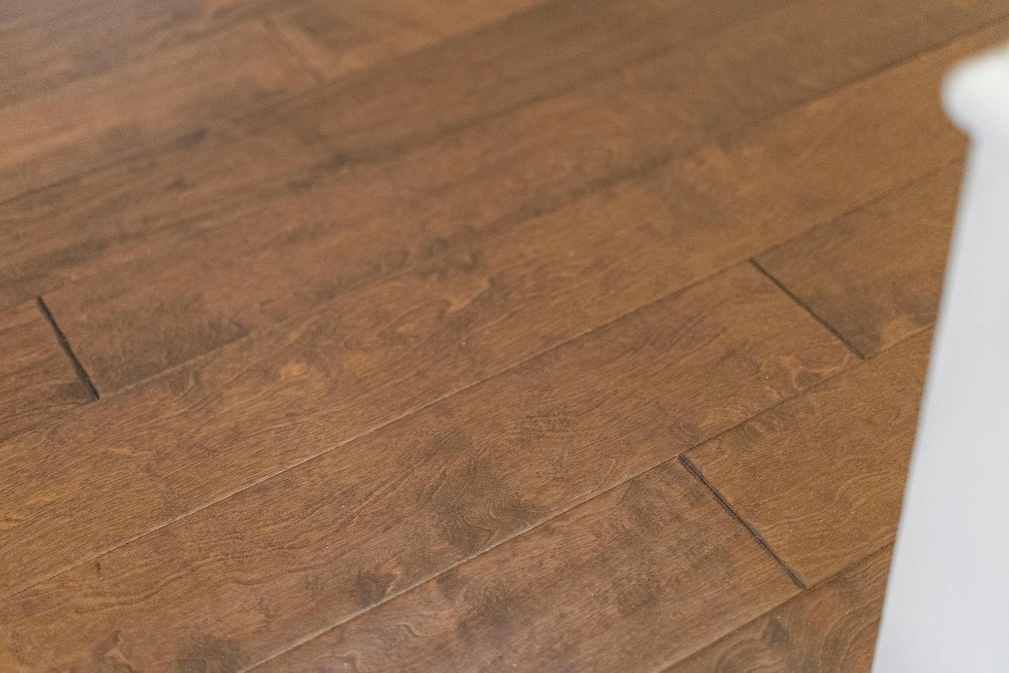 Warm brown hardwood flooring with wide planks and visible wood grain.