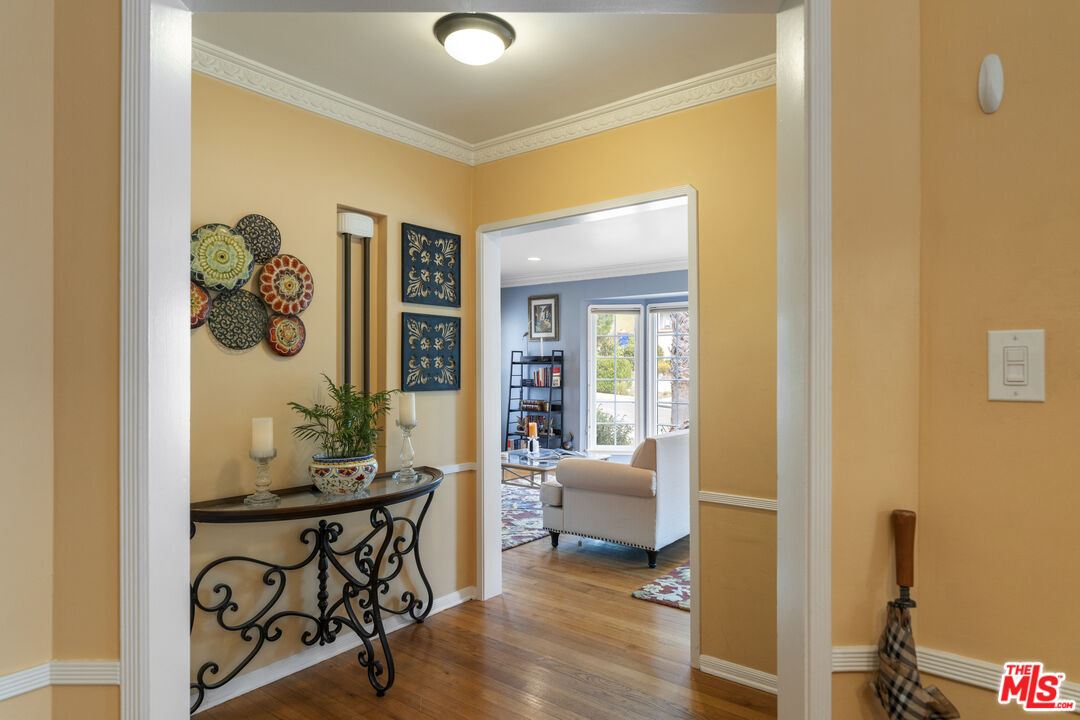 Entry foyer with a decorative console table and view through to a blue living room.