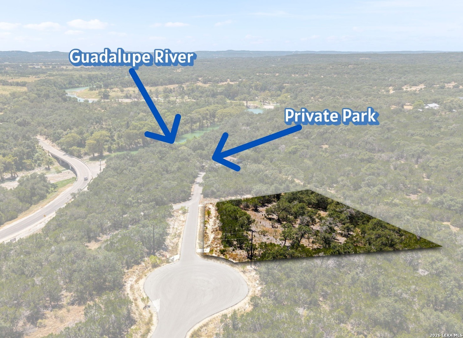 Aerial view of a wooded lot near the Guadalupe River and a private park.