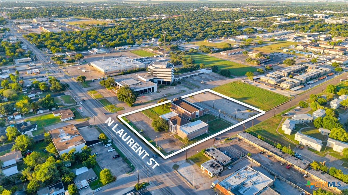 Aerial view of a commercial property parcel outlined in white at N Laurent St.