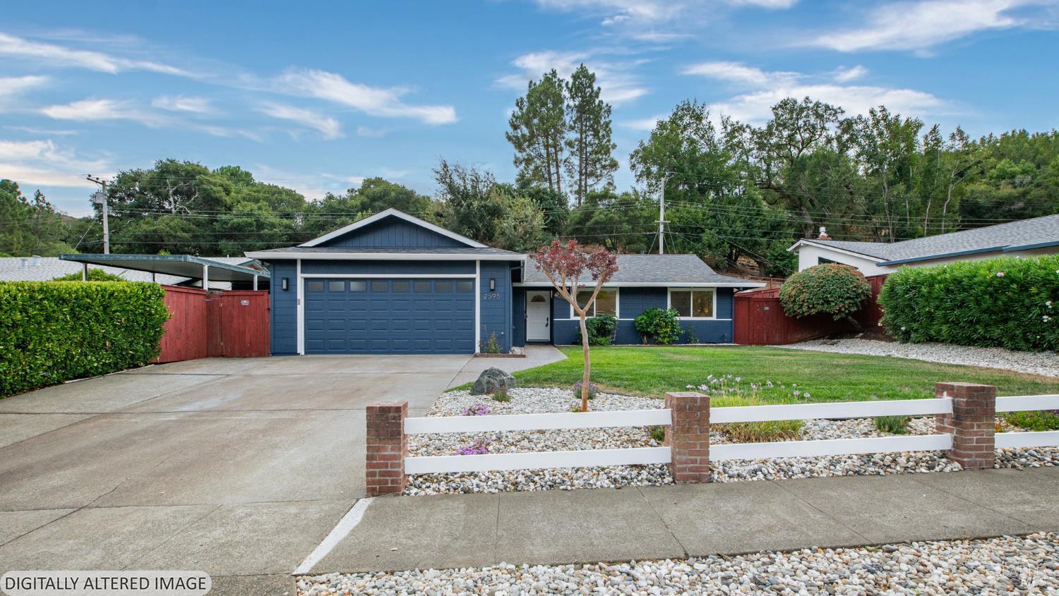 Blue single-story home with a wide garage, red side gates, and a low white-and-brick front fence.